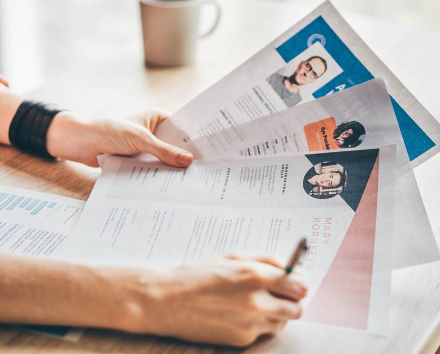 Above, business and hands with typing on laptop, desk and office for career in human resources. Woman, corporate worker and writing on keyboard with pc, technology and internet on cv for job search
